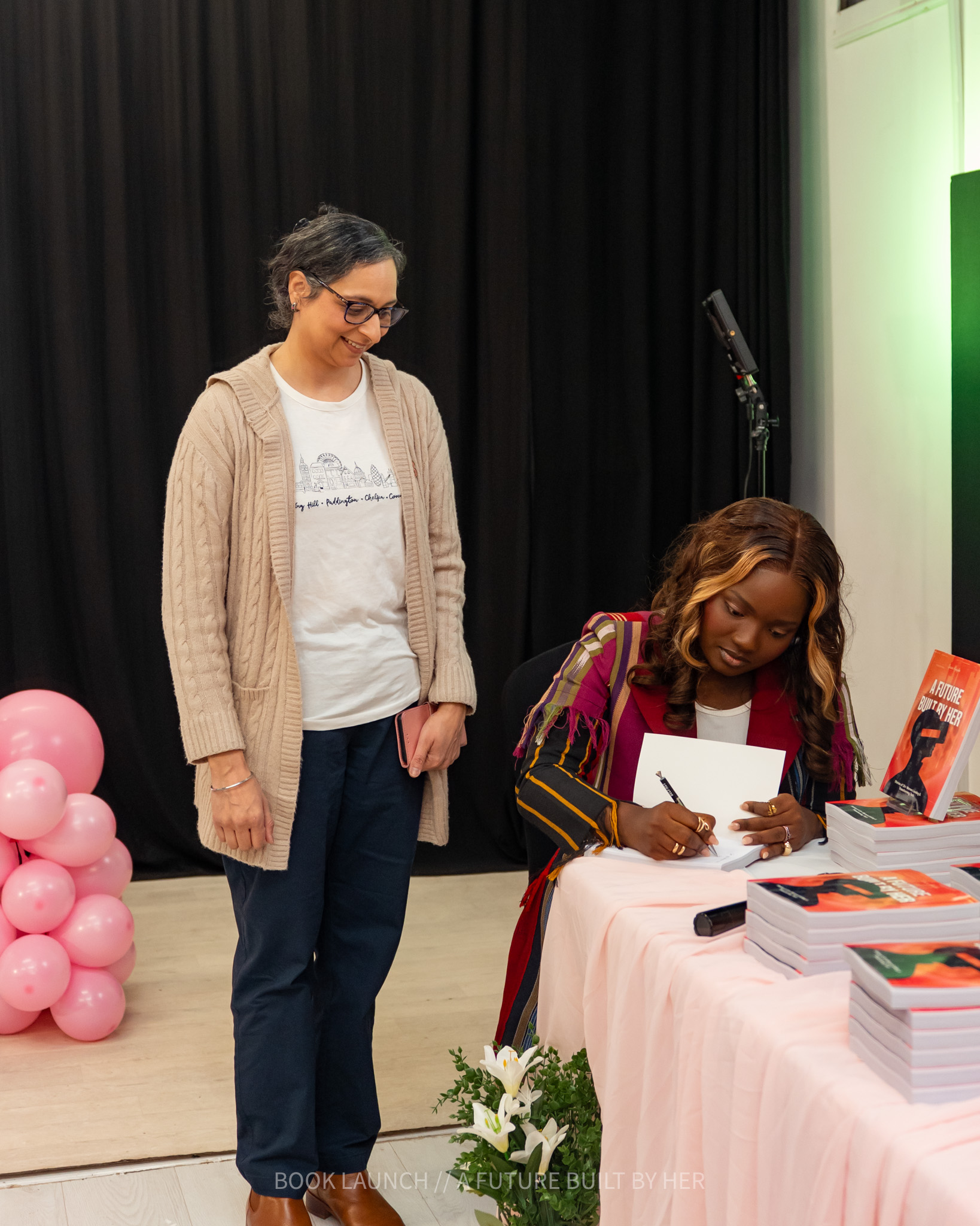 Grace signing books for attendees