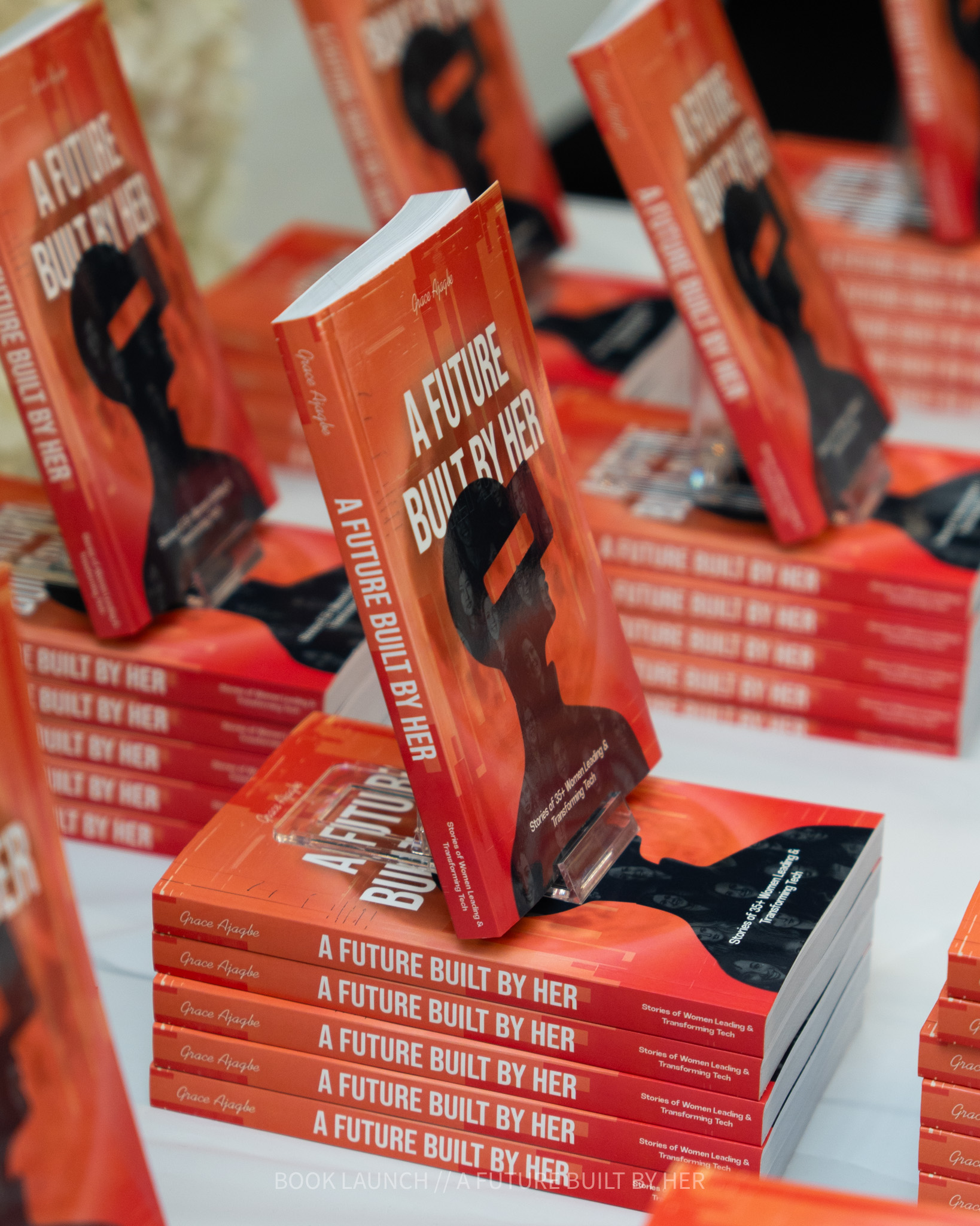 Stacks of A Future Built By Her books on display
