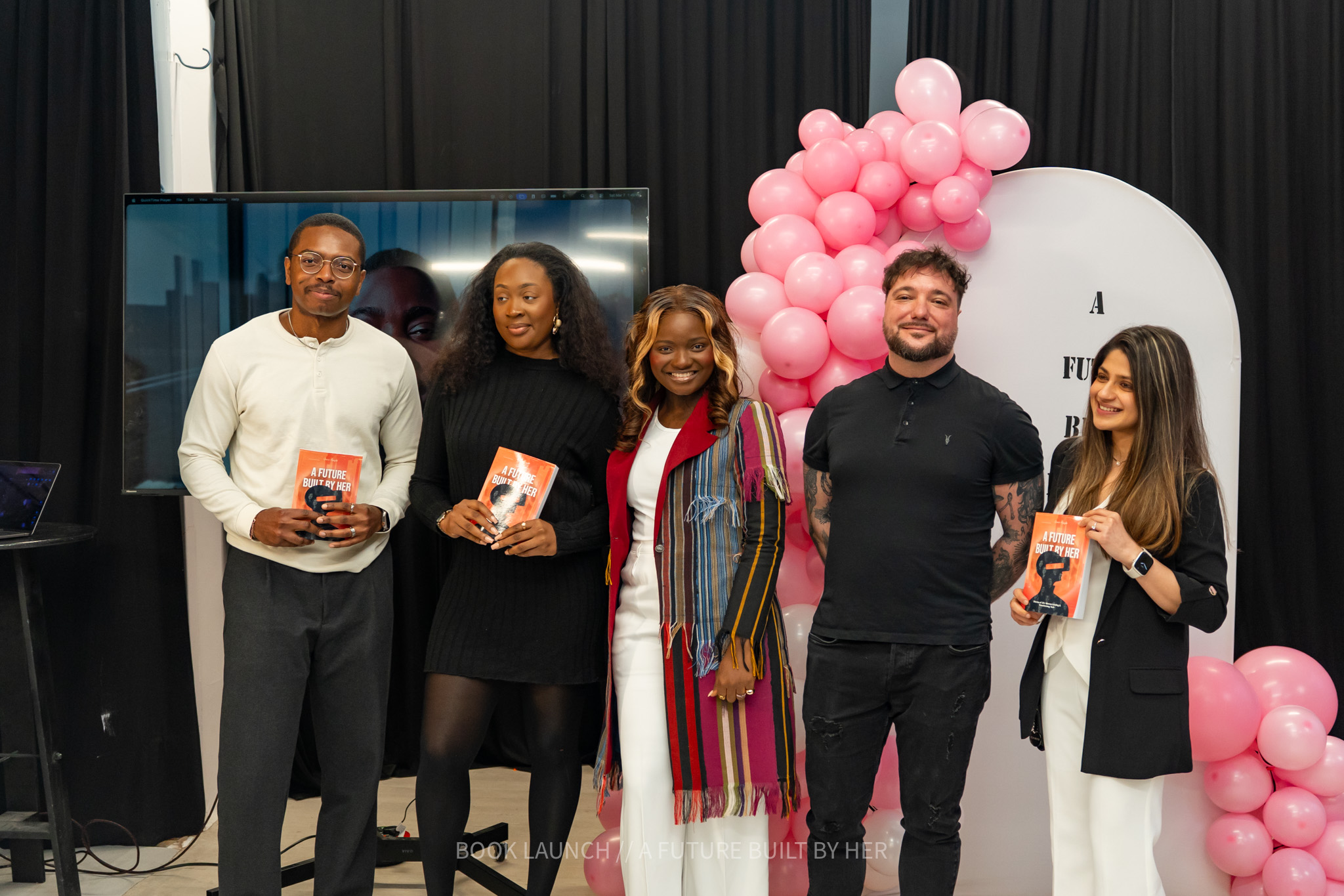 Guests holding copies of the book